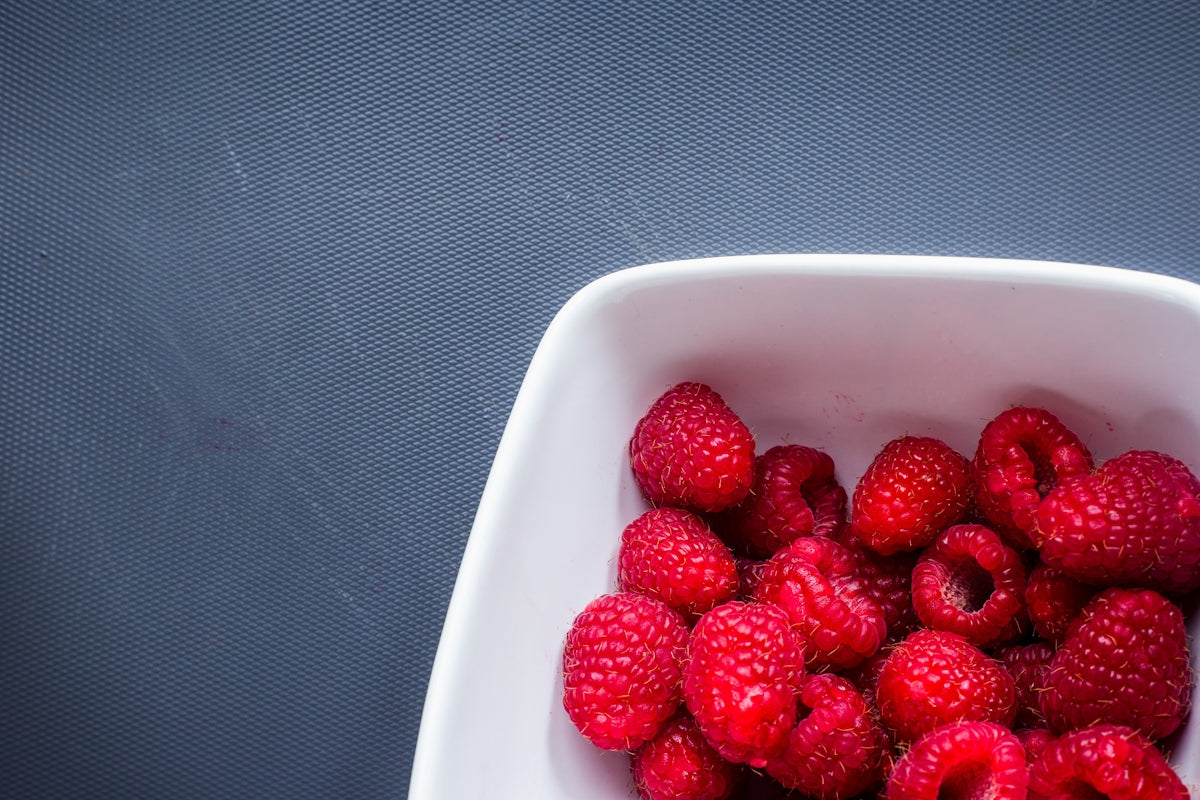 red strawberries in white ceramic bowl