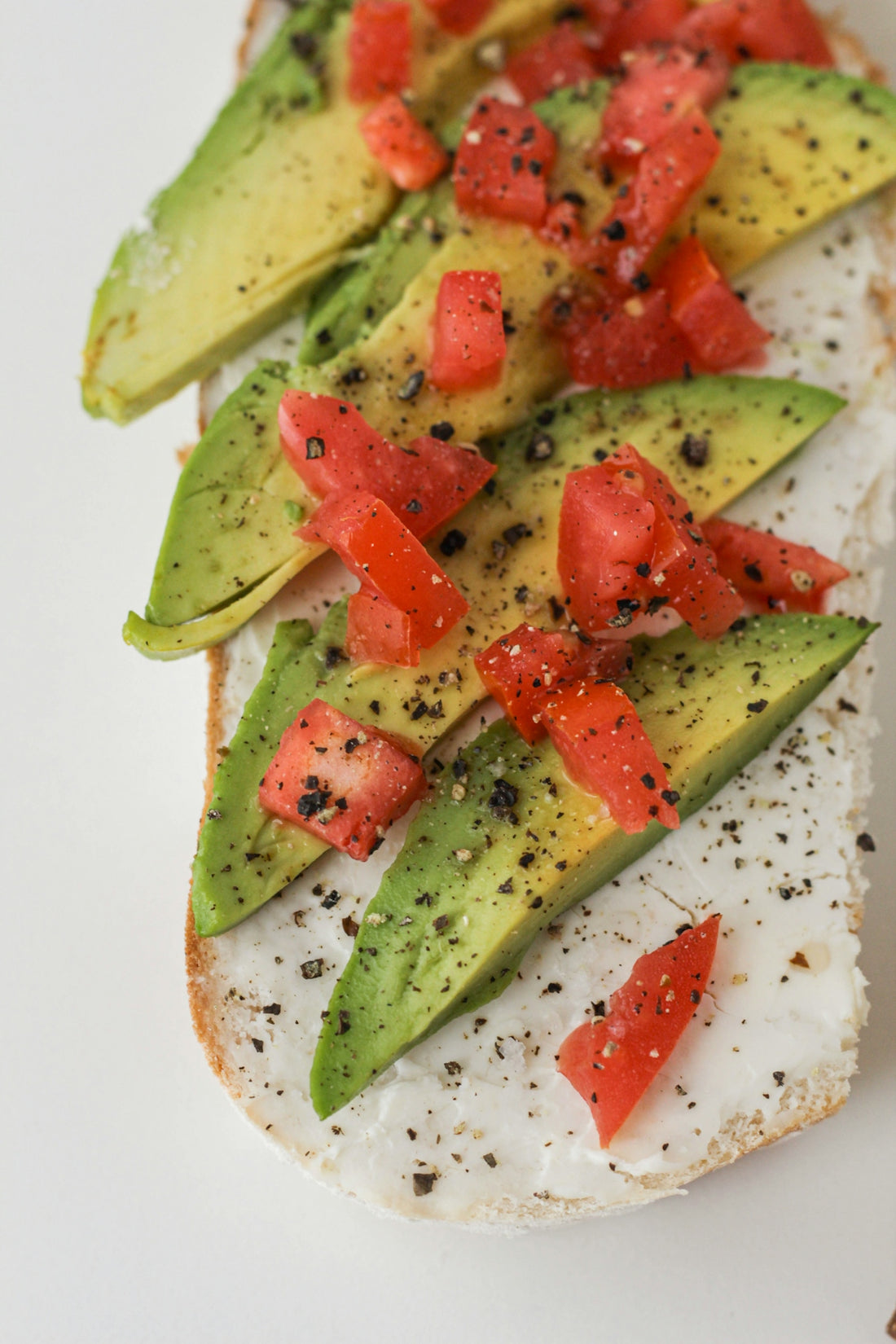 sliced tomato and green vegetable on white ceramic plate