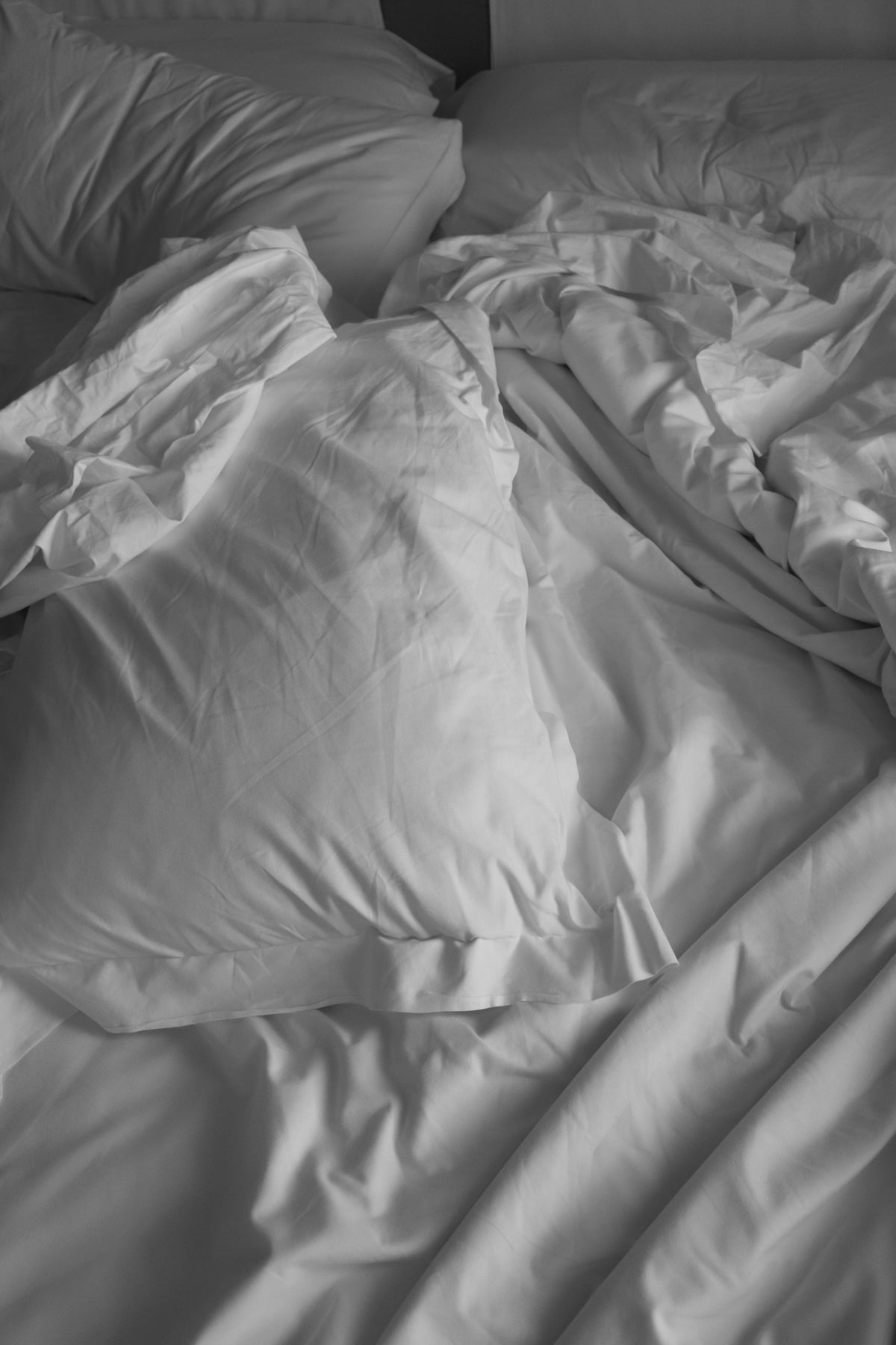 a bed with white sheets