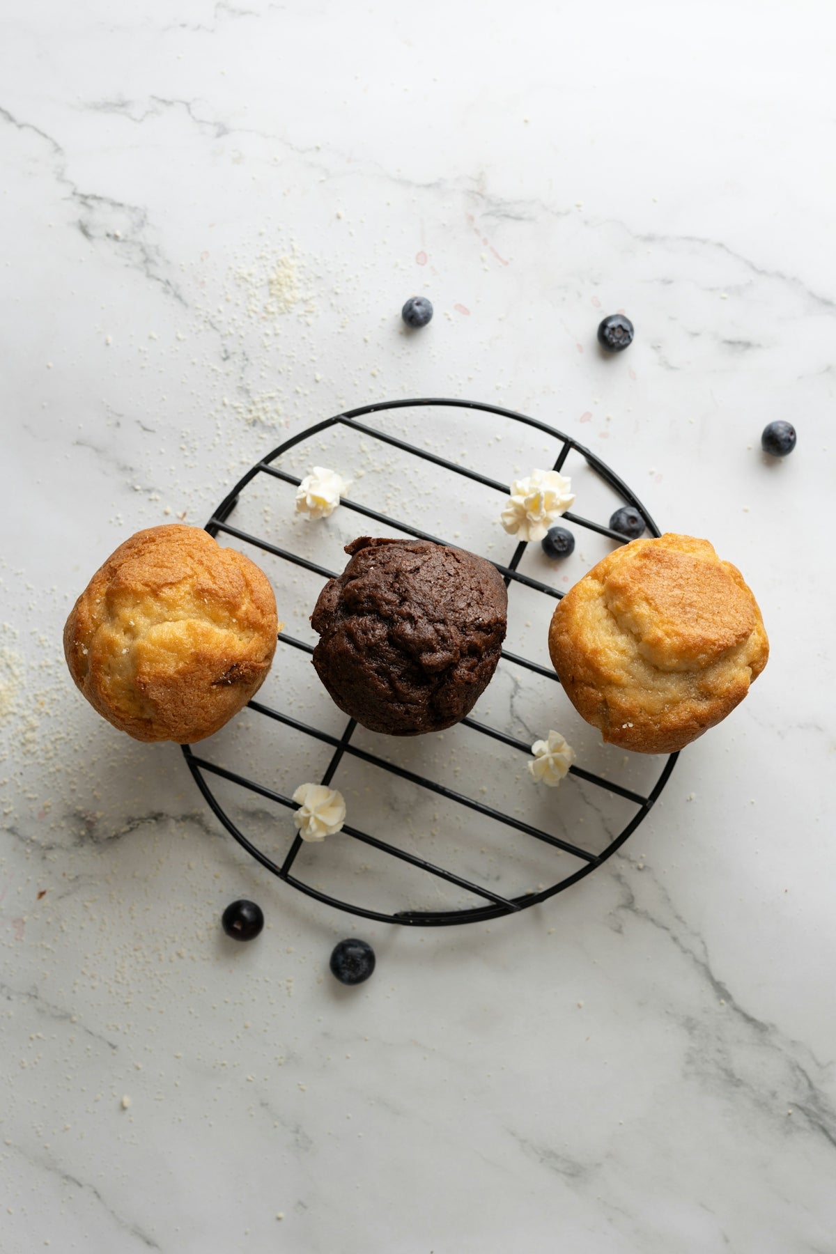 three muffins sitting on top of a wire rack