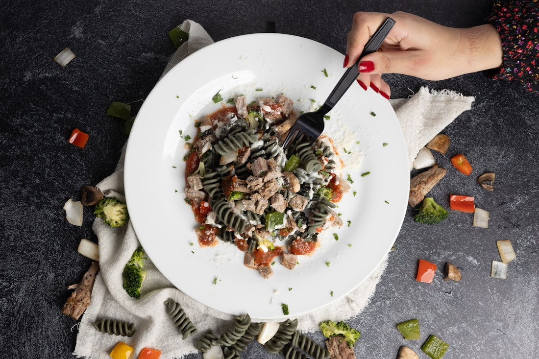 a plate of pasta with meat and vegetables