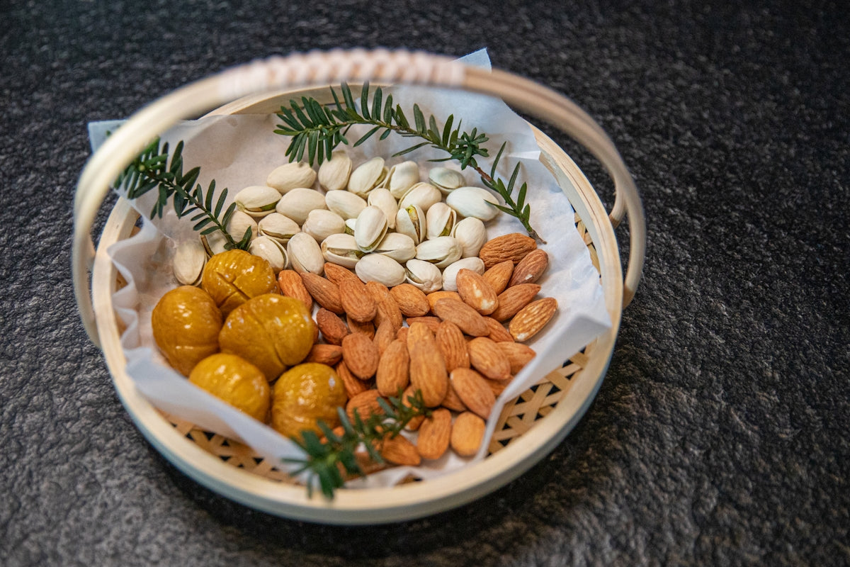 a basket filled with nuts and almonds on top of a table
